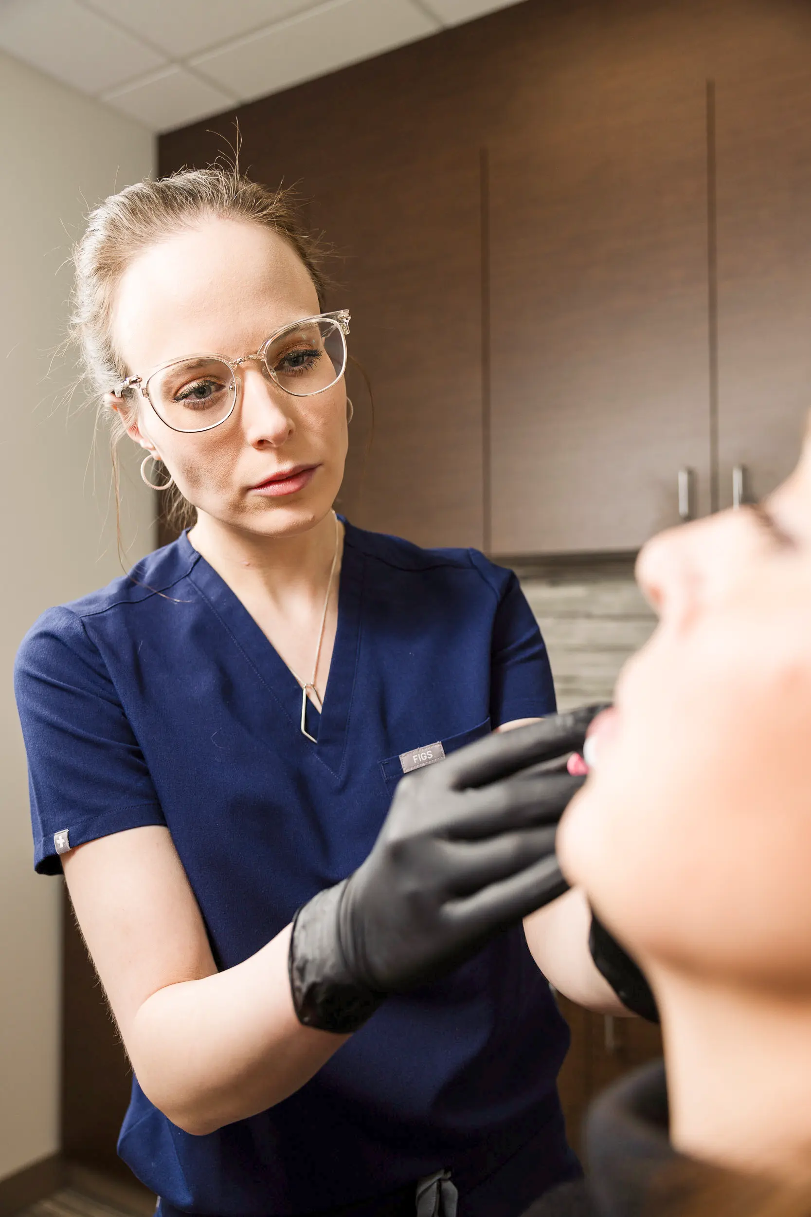 Adrianna Jensen, MD performing dermal filler treatment